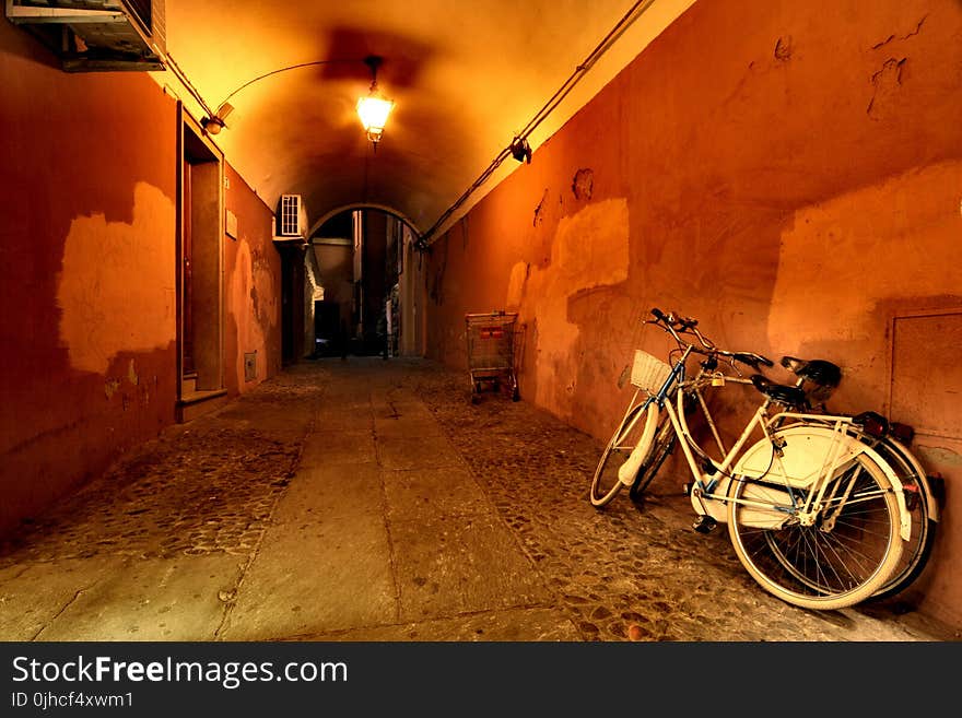 Two Beach Cruiser Bikes Beside Wall