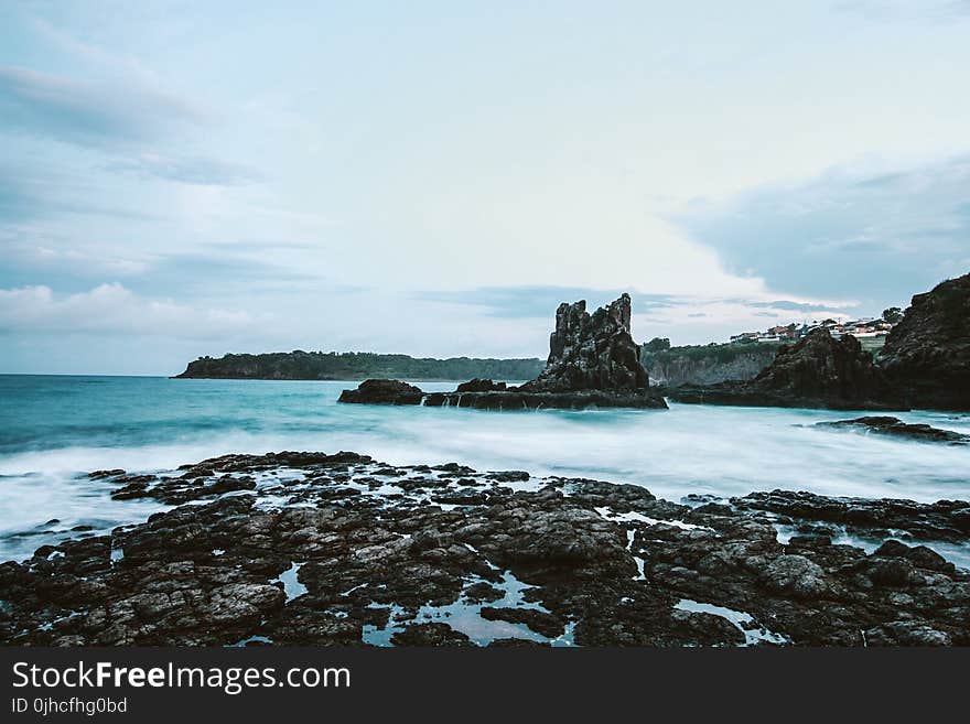 Photo Of Seashore With Rocks During Daylight