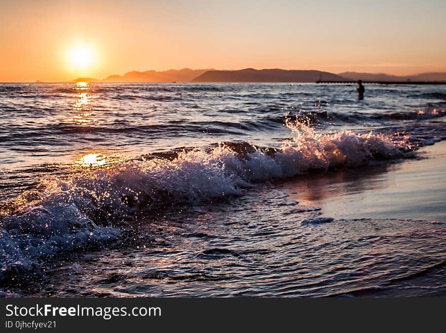 Person on Beach during Golden Hour