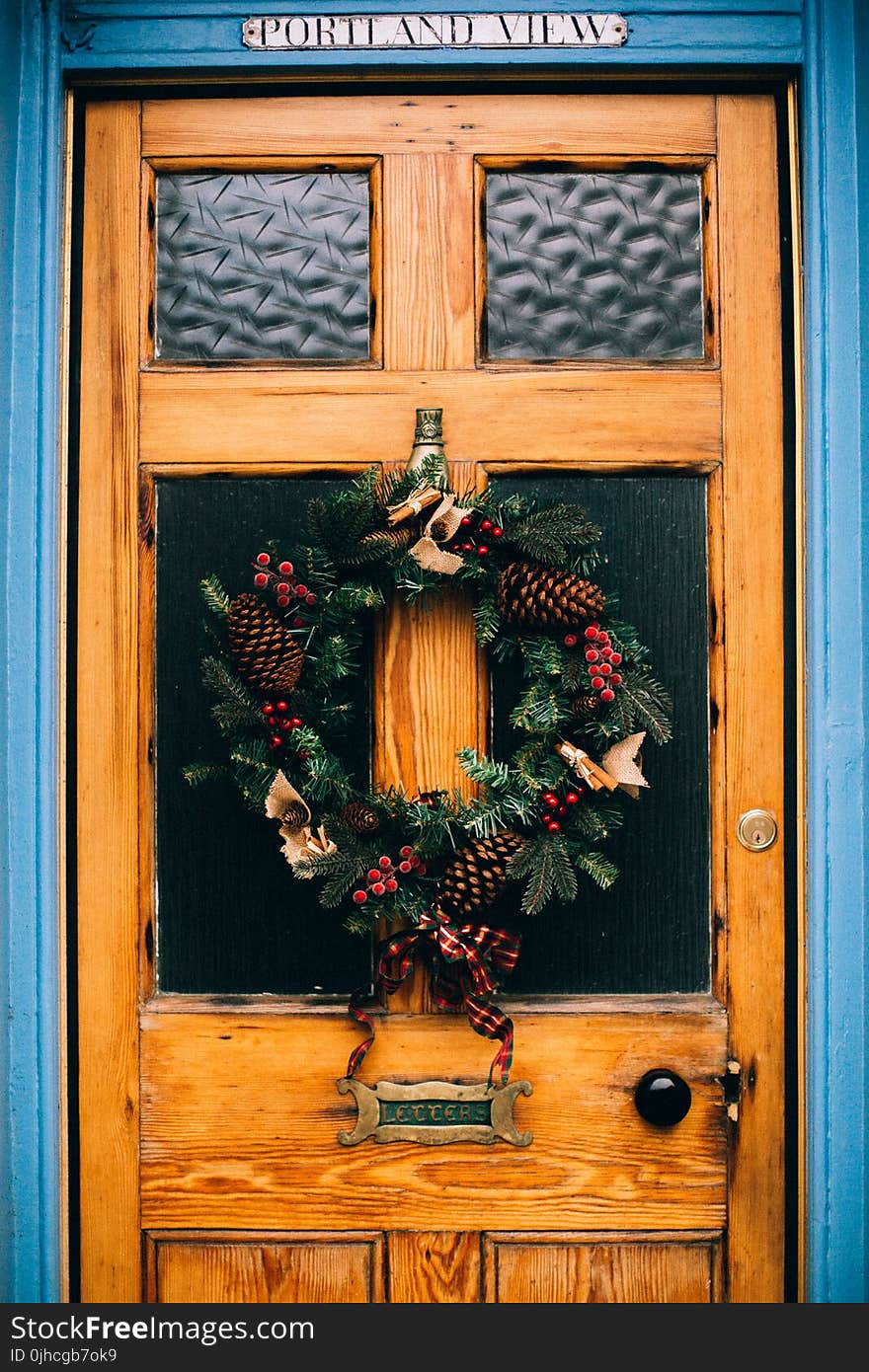 Brown Wooden Door With Pine Cone Wreath