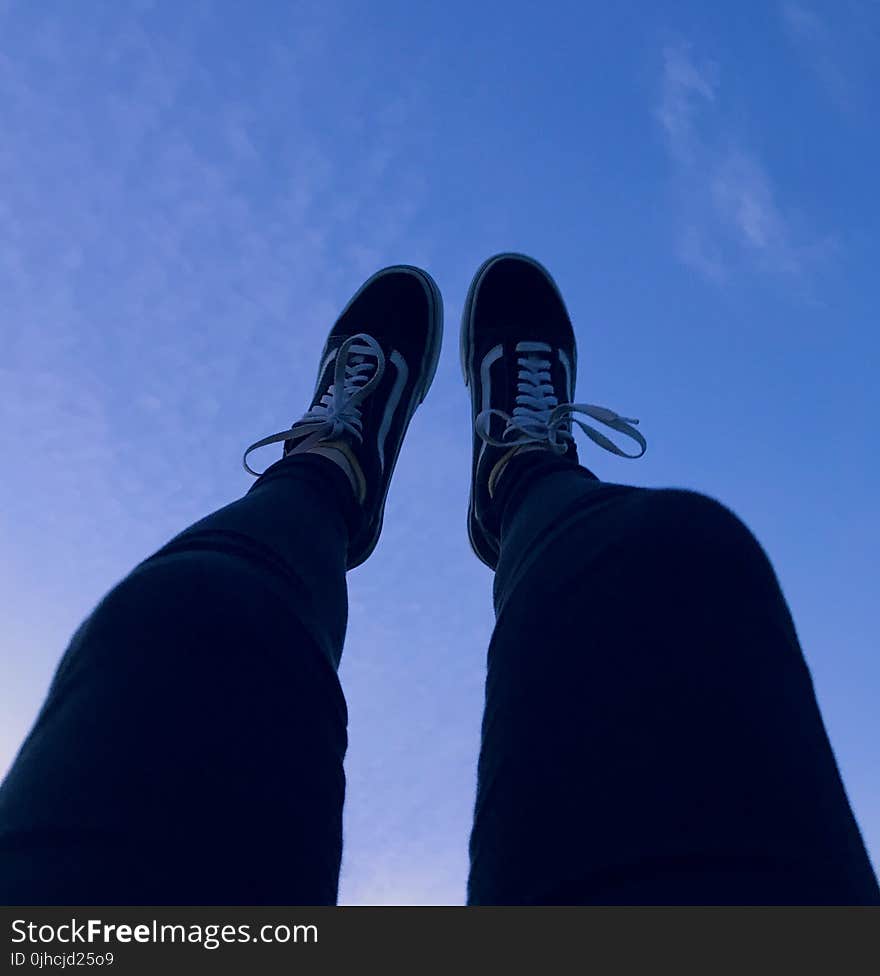 Person Wearing Vans Old Skool Sneakers Raising His Feet Pointing to They Sky