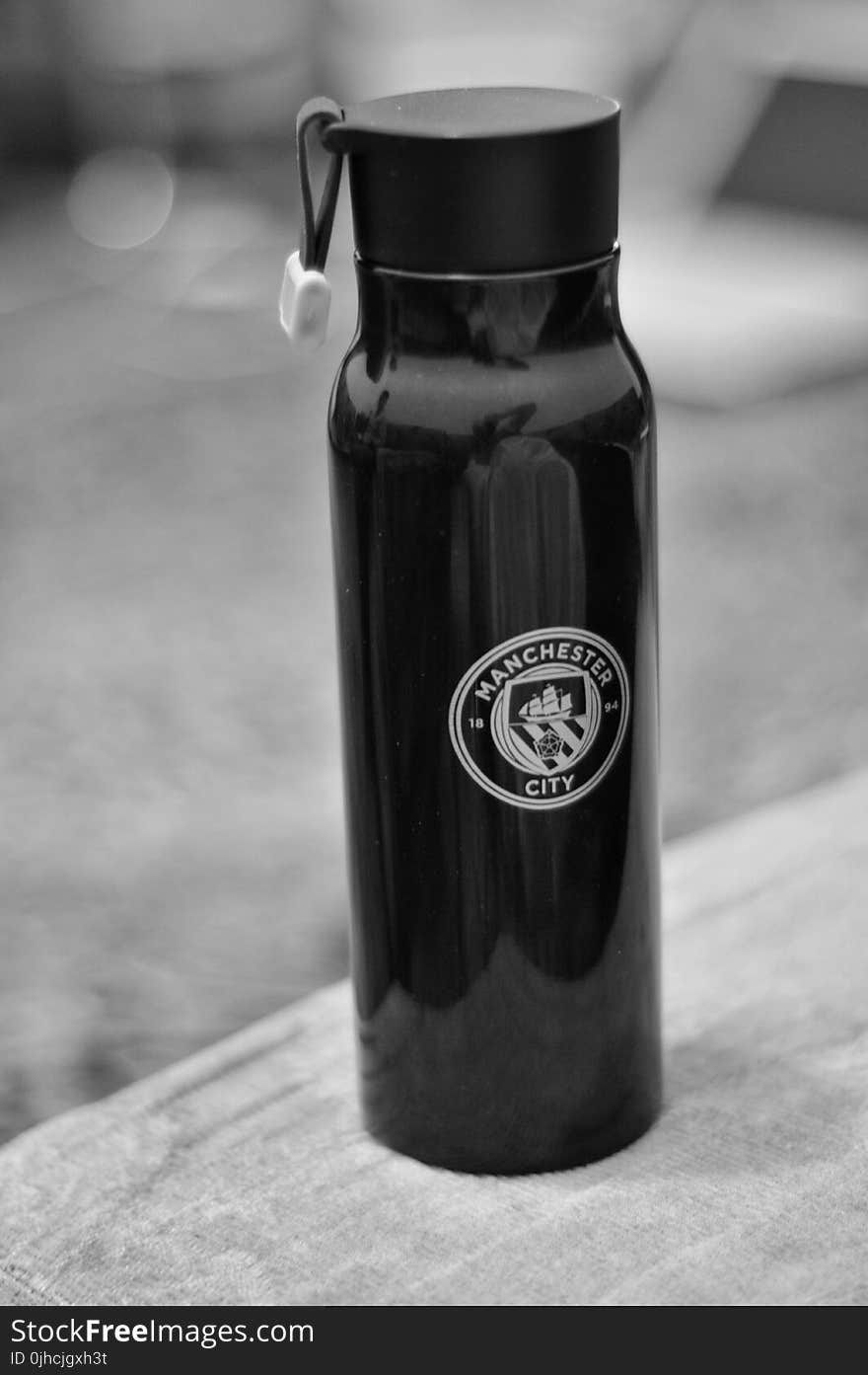 Selective Focus Photography of Manchester City Sports Bottle