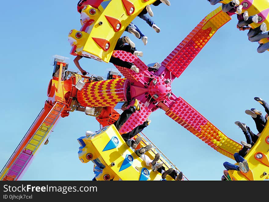 People Riding a Swing in the Amusement Park