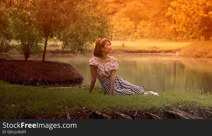 Woman in Dress Lying on Grass