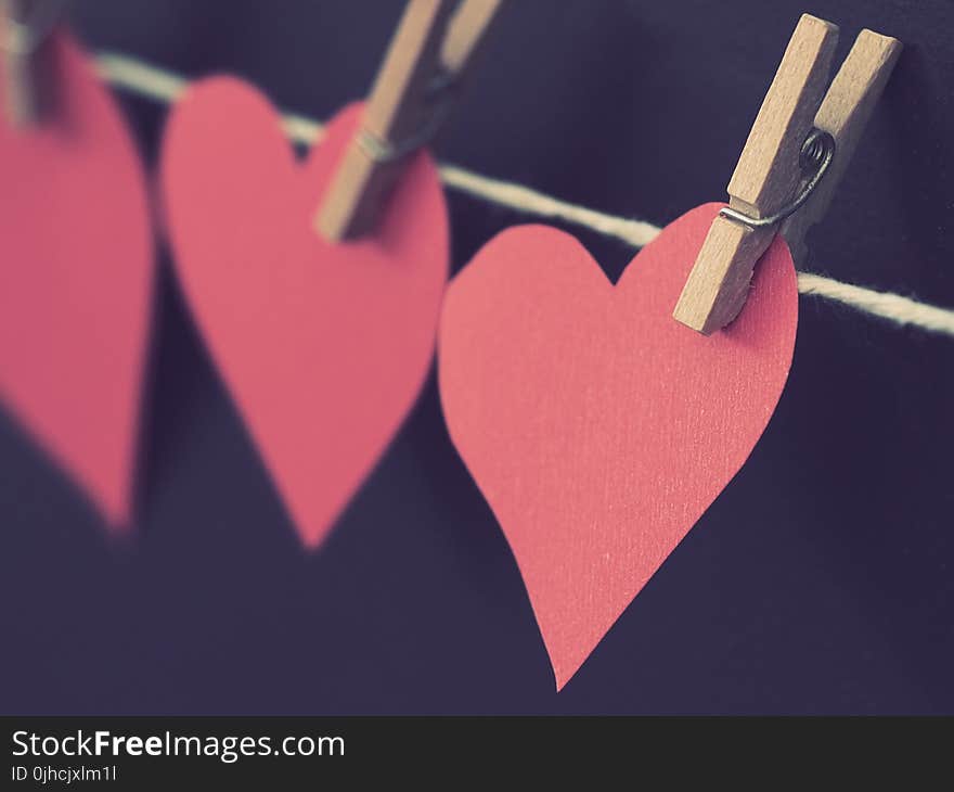 Photo of Red Heart-shaped Paper Hanging on Rope