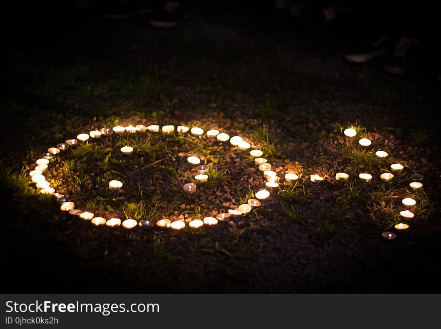 Arrow Shaped Lighted Tealight Candles on Grass