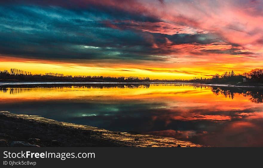 Body of Water Under by Cirrus Clouds during Golden Hour