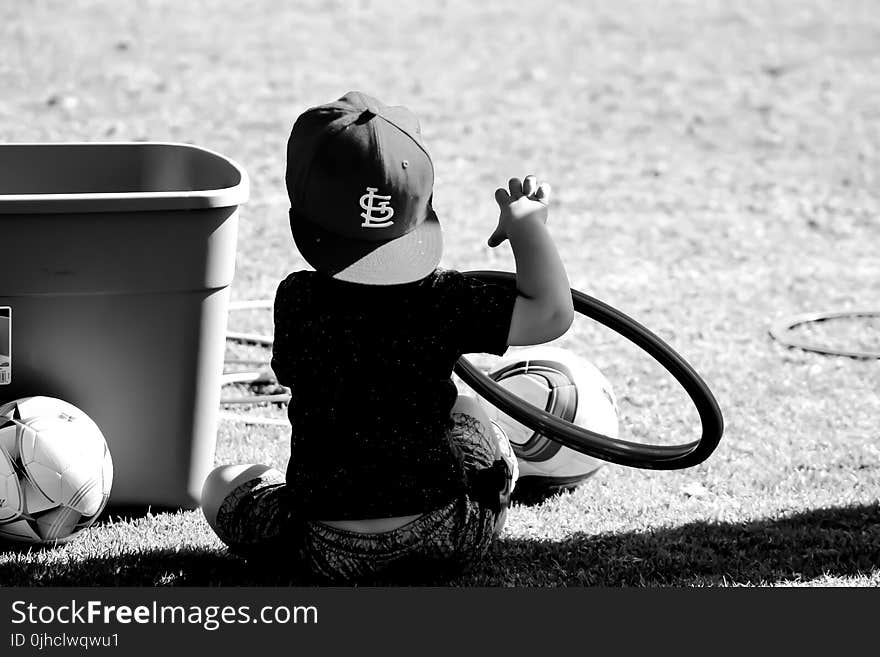 Grayscale Photo of Boy Wearing St. Louis Cap