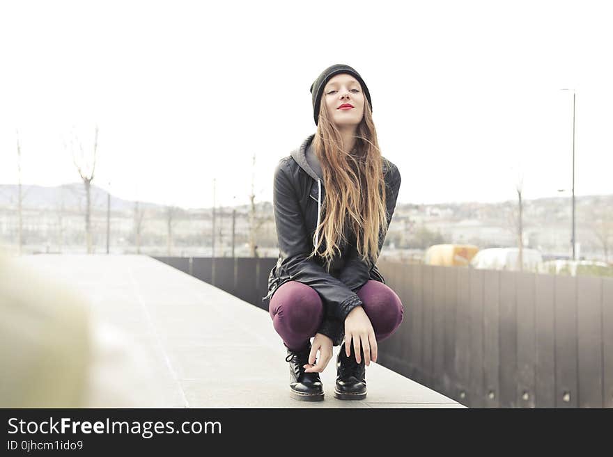 Selective Photo of Woman in Gray Hooded Jacket Doing Crouch Position