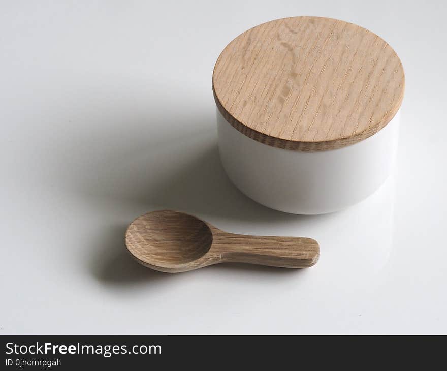 Close-up Photography of White and Brown Wooden Container and Spoon