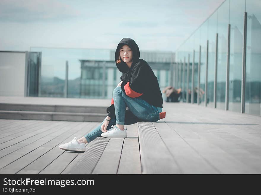 Woman in Black Hoodie Sitting