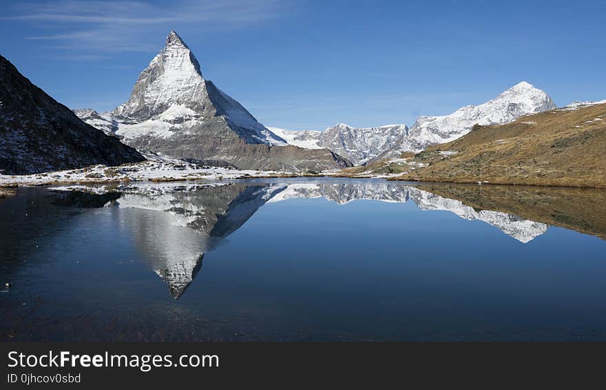 Photography of Snow Mountains Near Lake