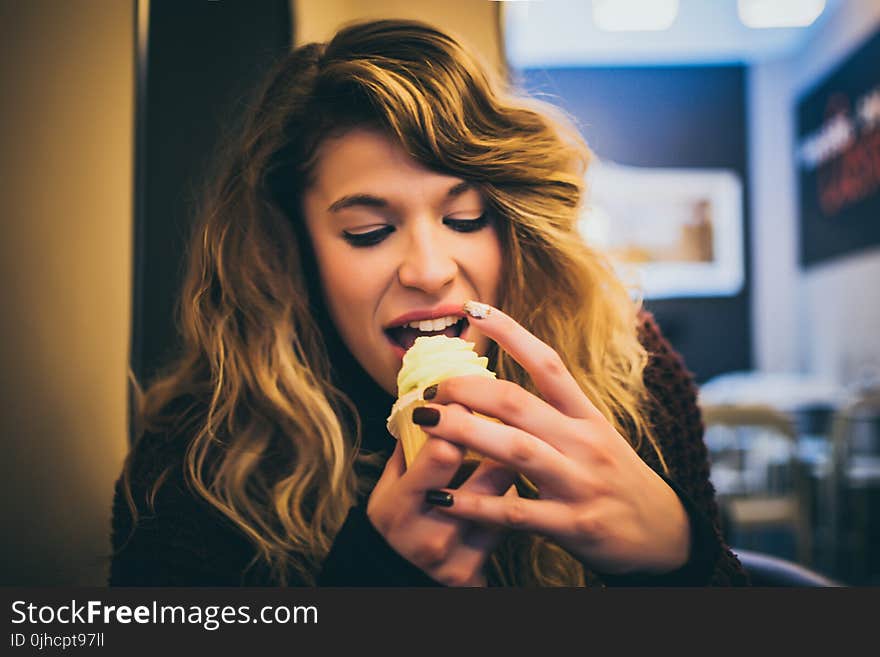 Long Blonde Haired Woman Eating Ice Cream