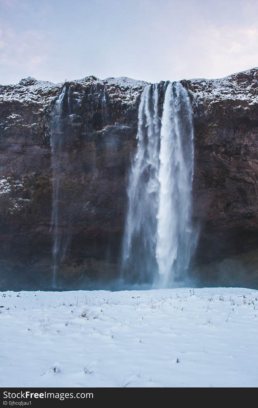 Snow Falling from Cliff Photo