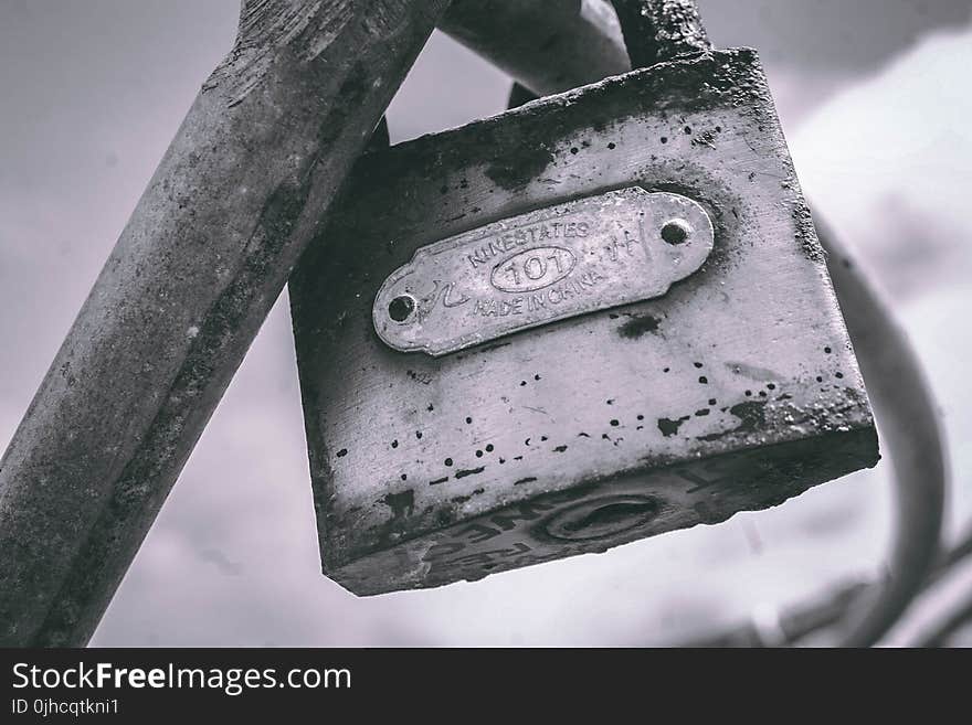 Macro Photography of Gray Metal Padlock on Gray Metal Bar