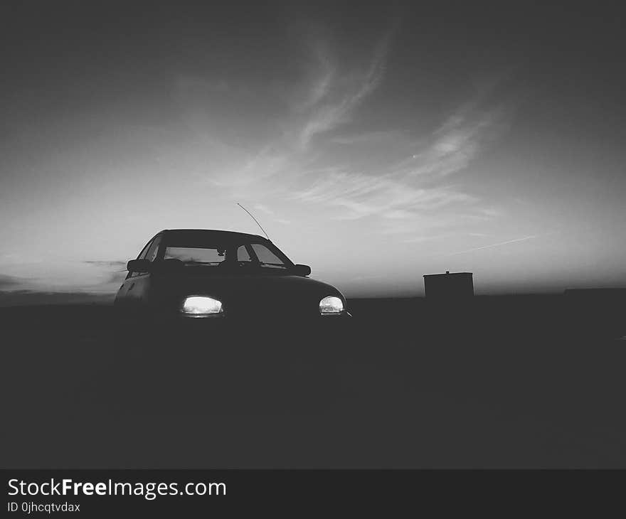 Silhouette Of Car With Turned On Light