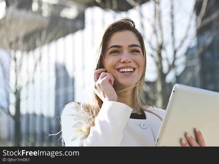 Woman In White Blazer Holding Tablet Computer