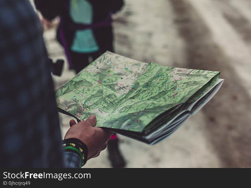 Person Holding Outlined Map