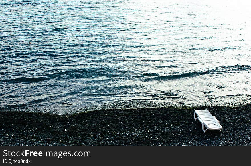 White Lounge Chair on Beach