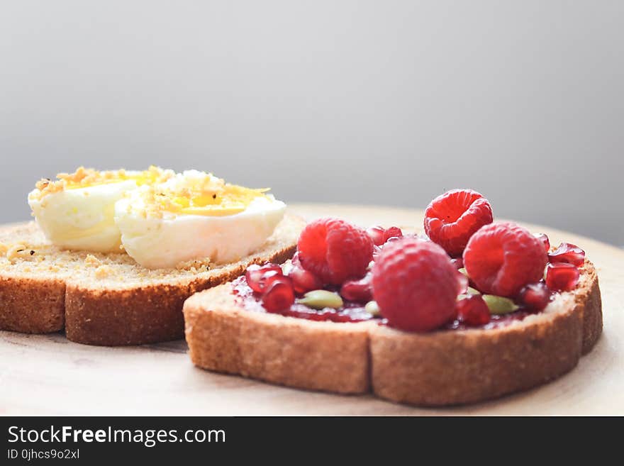 Two Boiled Egg and Raspberries on Loaf Bread