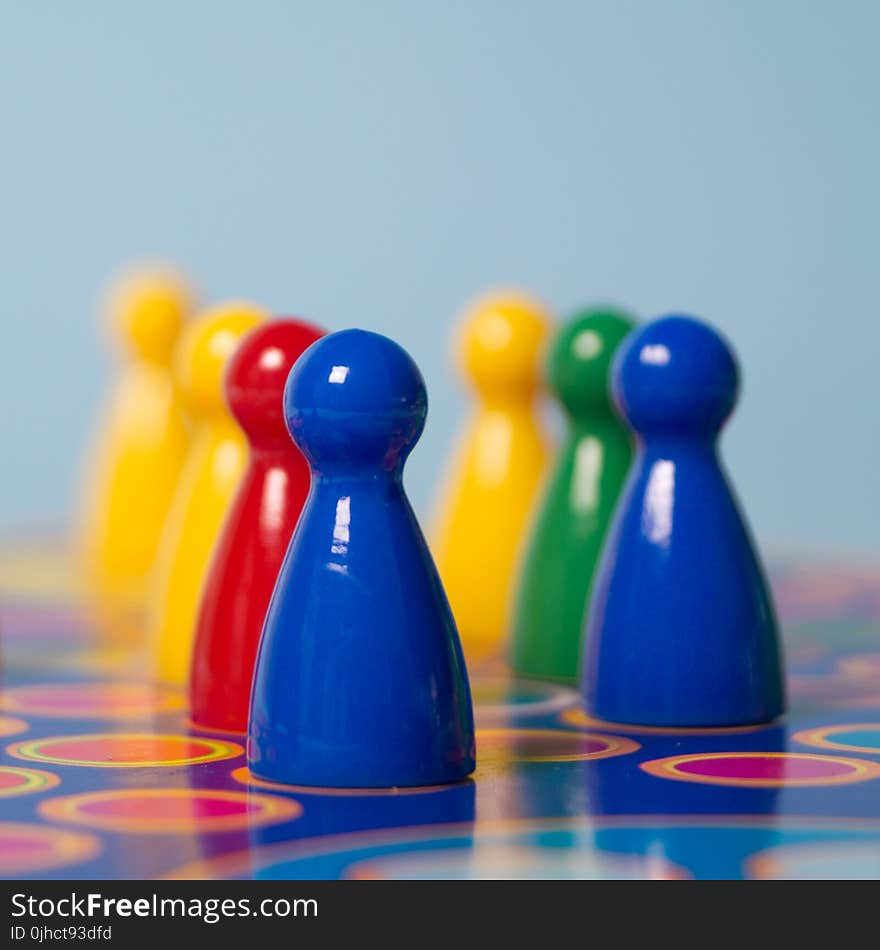 Closeup Photography of Yellow, Red, Green, and Blue Chess Piece