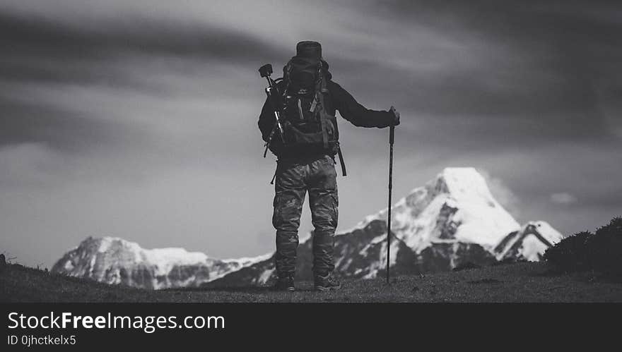 Grayscale Photo of Man Standing on Ground