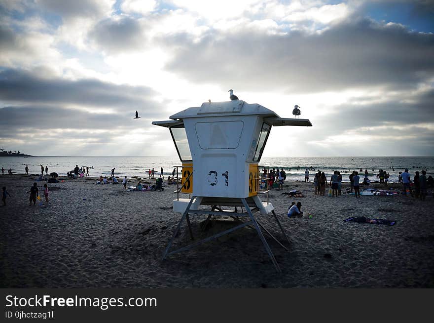 People Near Sea Under White and Blue Sky