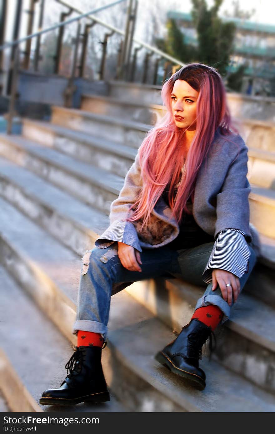 Woman With Pink Long Hair Sitting