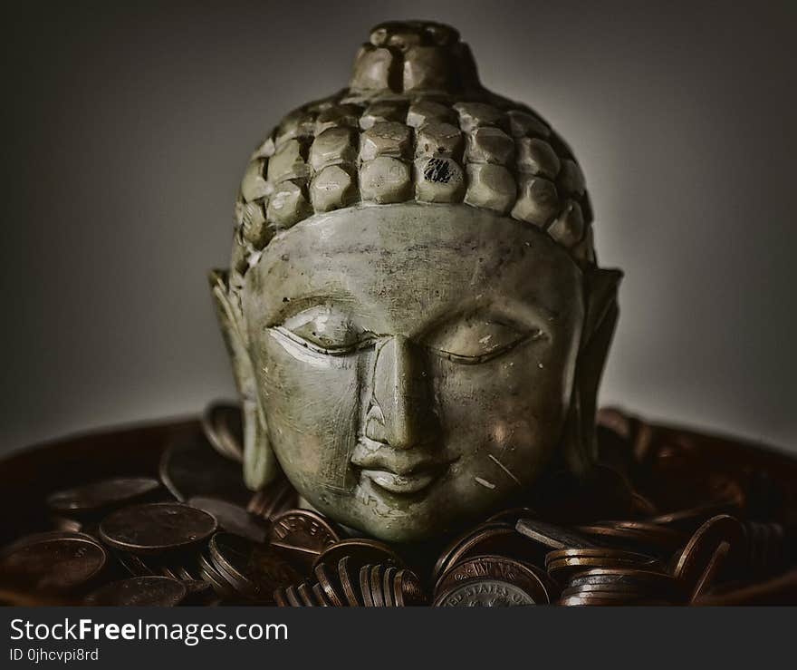 Gautama Buddha Bust Surrounded by Coins