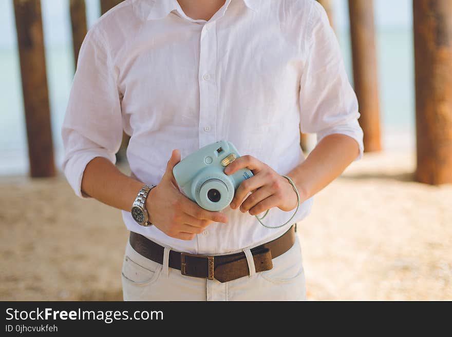 Man Holds Blue Fujufilm Instax Mini Camera