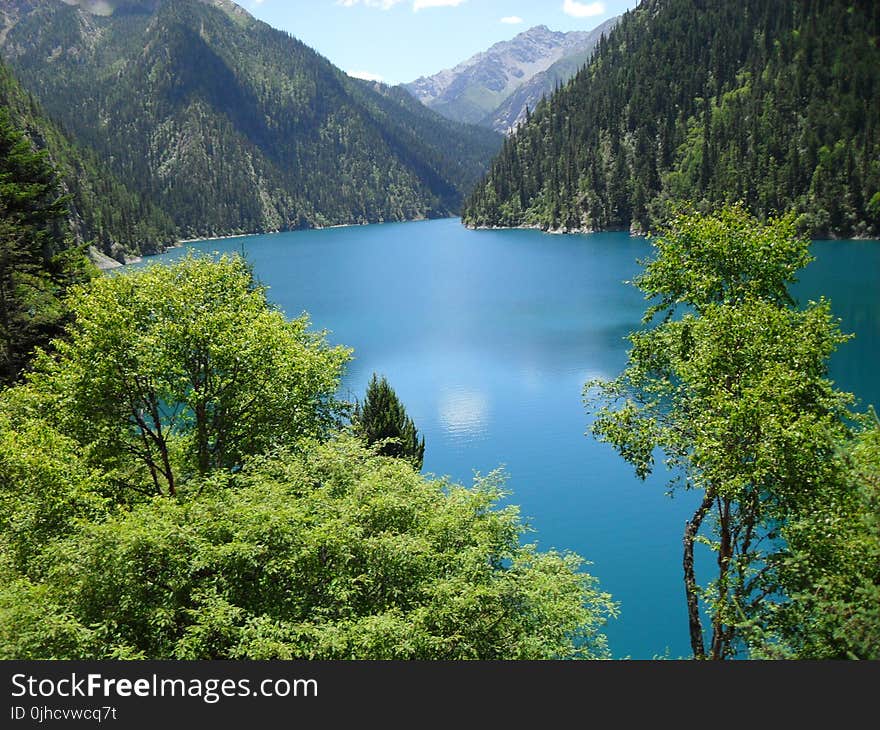 Blue Body of Water and Green Mountains Long Exposure Photography