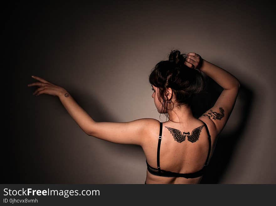 Woman in Eagle Tattoo in Back Wearing Black Bra