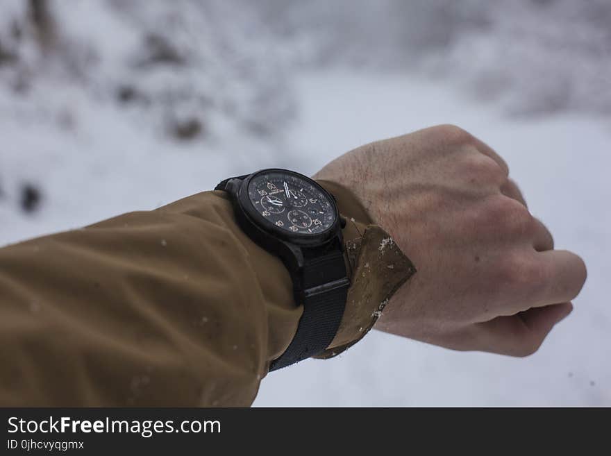 Person in Brown Long-sleeved Top Wearing Chronograph Watch