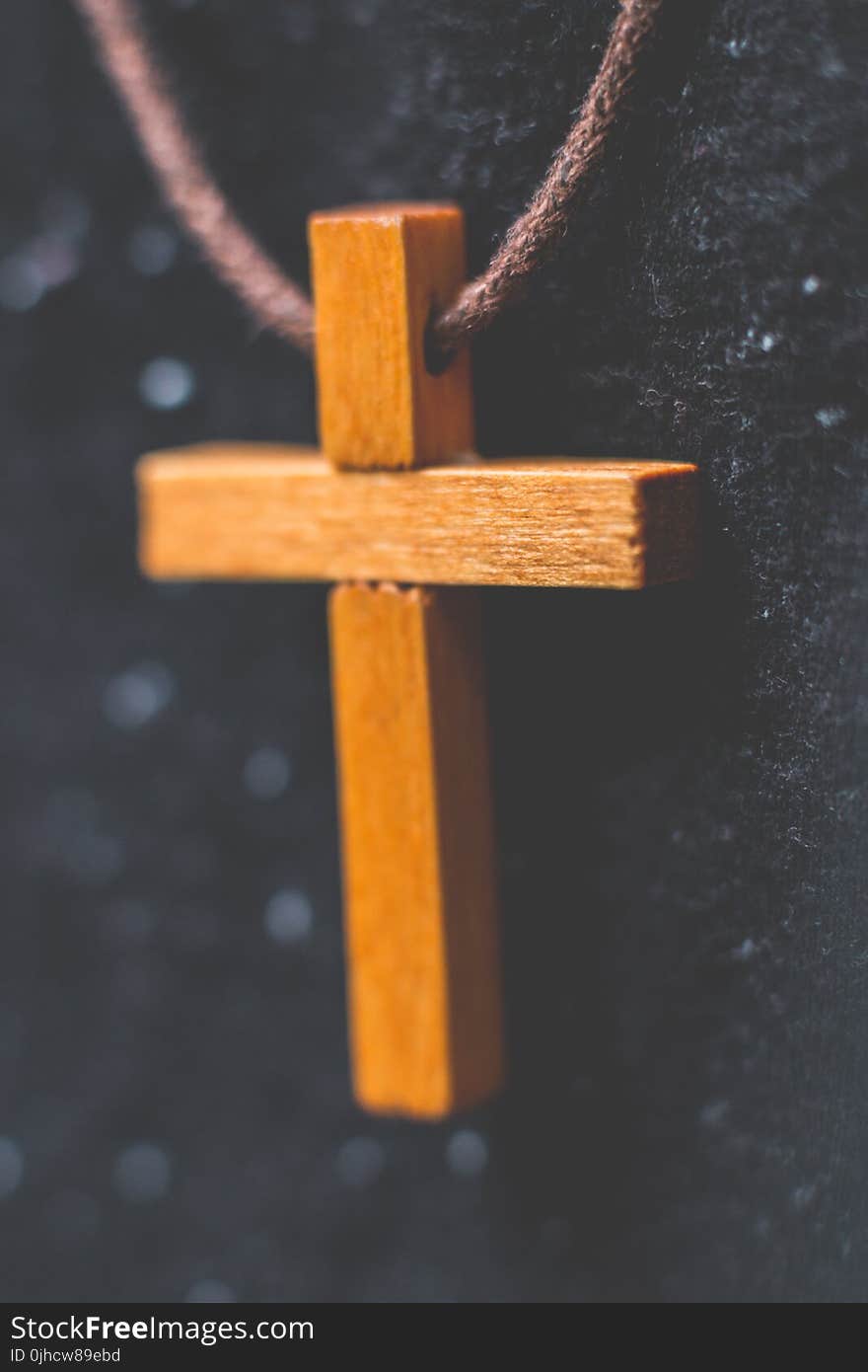 Brown Wooden Cross Pendant on Closeup Photography