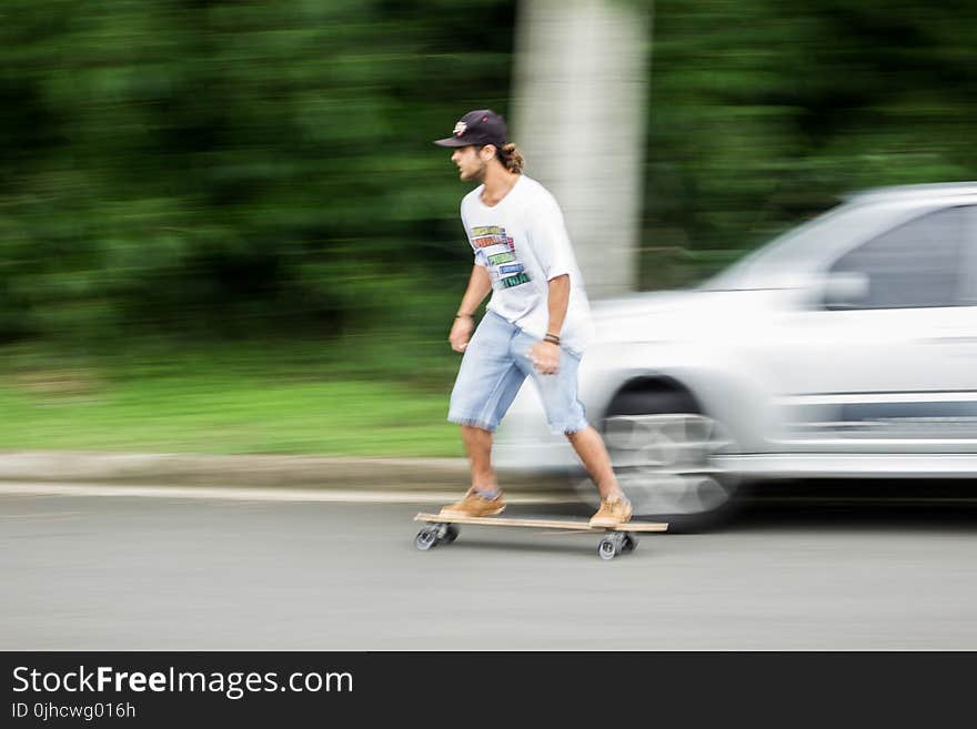 Man Playing Longboard on Road