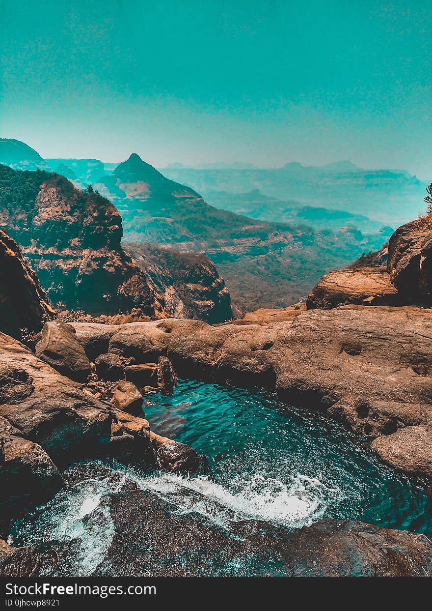 Brown Mountain With Body of Water