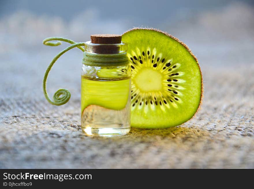 Kiwi Beside Glass Bottle