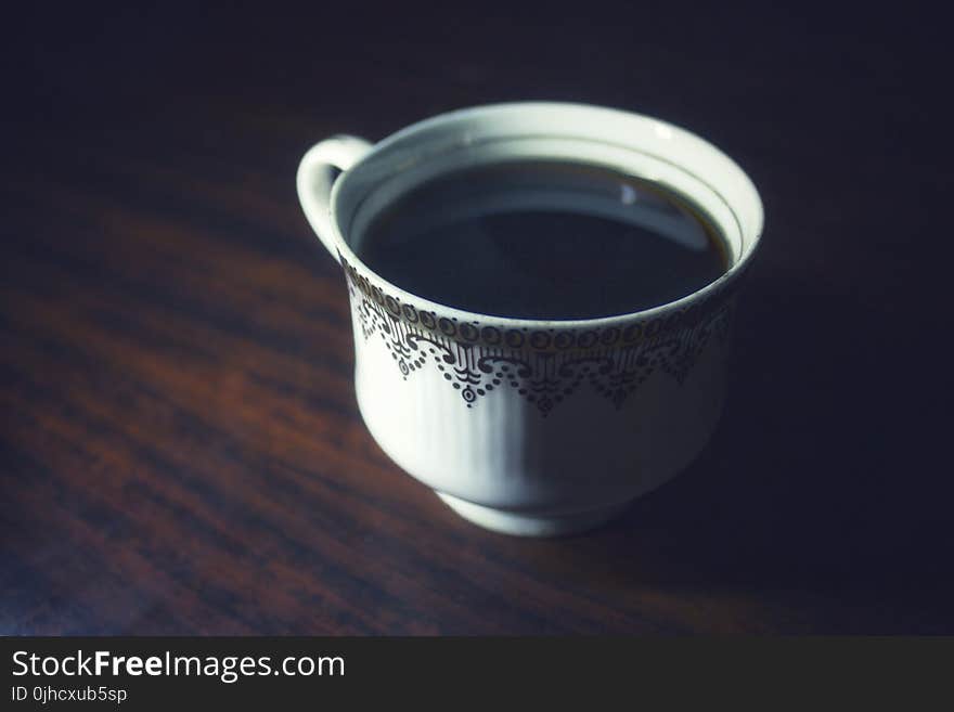 Coffee Served in White Teacup on Brown Wooden Surface