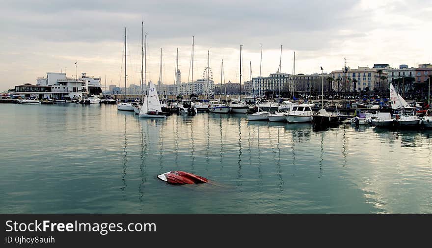 White Power Boat and Yacht Parked on Body of Water