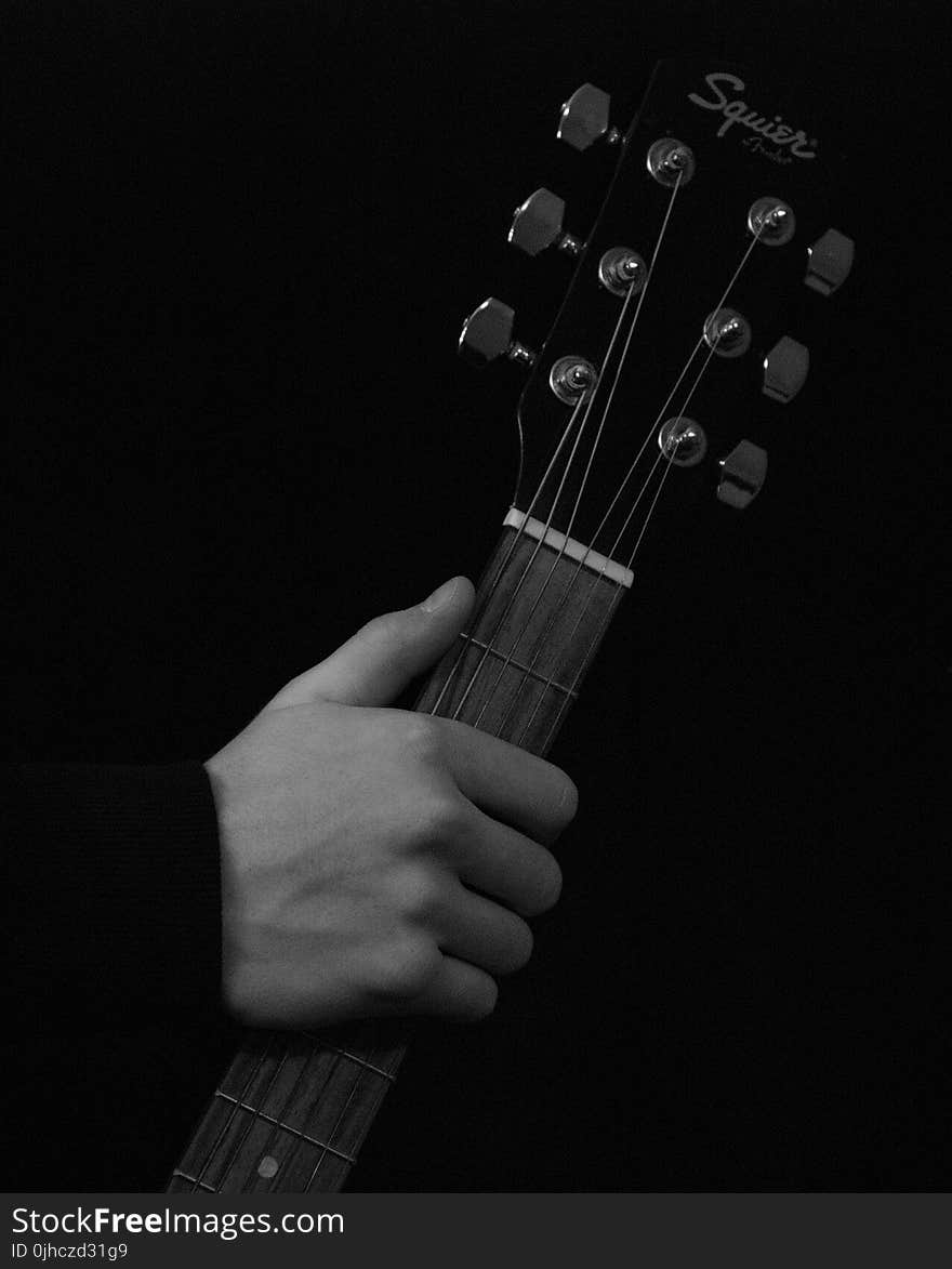 Person Holding Black Squier Fender Guitar