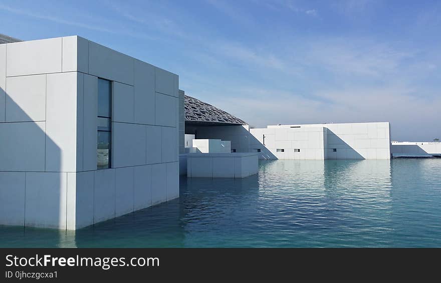 White Building Surrounded With Water