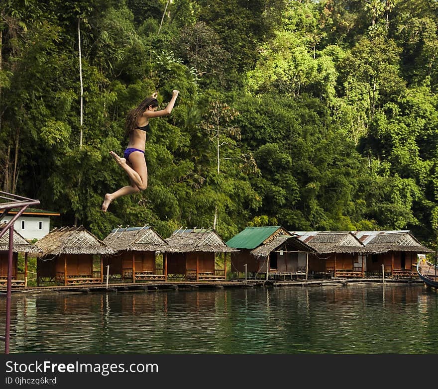 Photography of a Woman Jumping Into The Water