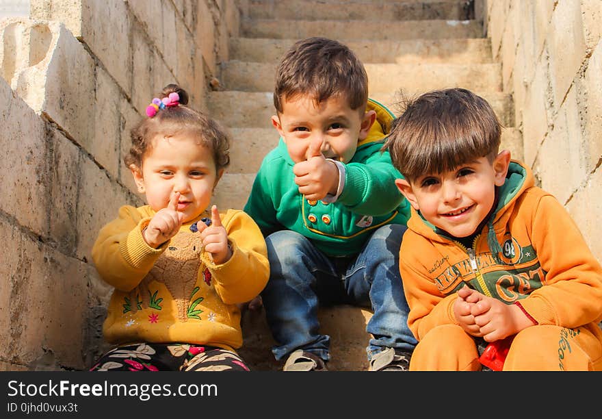 Children Sitting On The Stairs Doing Pose