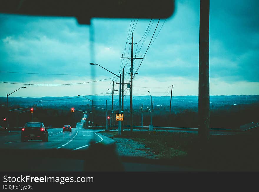 Road With Light Posts from Inside Car&#x27;s Point of View