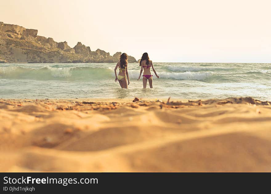 Photo of Women Wearing a Bikini on Beach