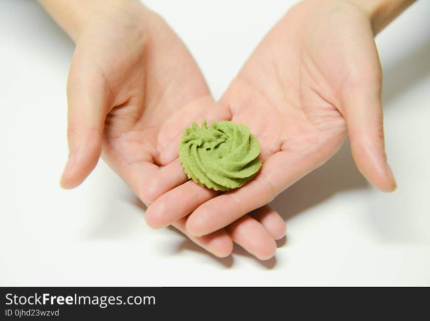 Close-Up Photography of a Person Holding Icing