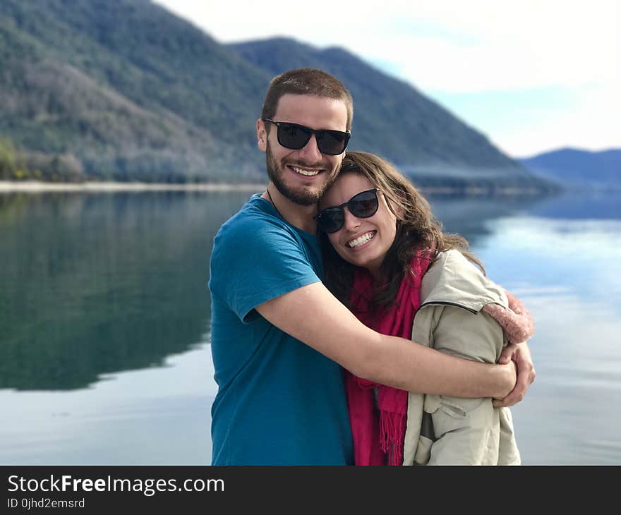 Hugging Couple Near the Body of Water