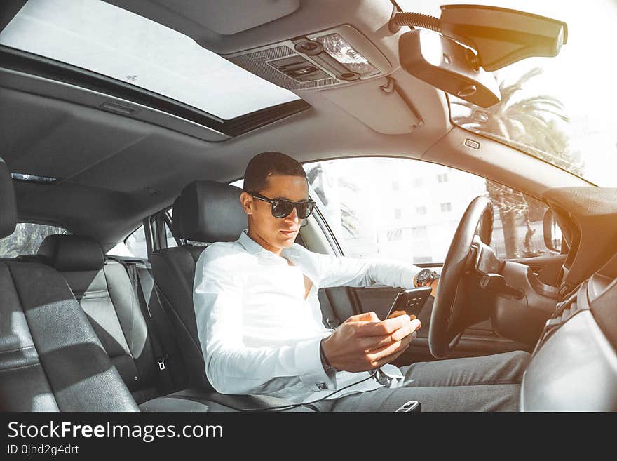 Man in White Dress Shirt Holding Smartphone