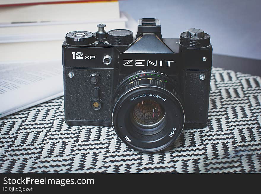 Black Zenit Dslr Camera on Top of Table