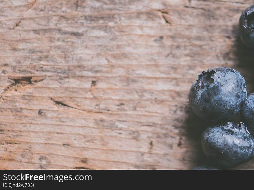 Close-Up Photography of Blueberries on Wooden Surface